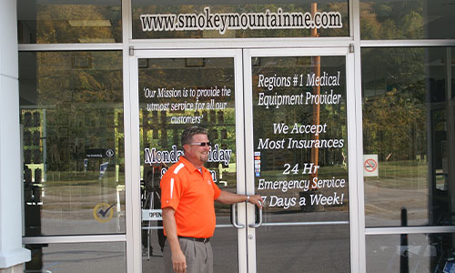 Man walking into Smokey Mountain Medical Equipment store.